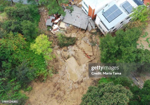 An aerial view of a home destroyed by a mudslide as a powerful long-duration atmospheric river storm, the second in less than a week, continues to...