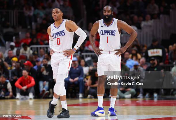 Russell Westbrook and James Harden of the LA Clippers stand during free throws in the fourth quarter against the Atlanta Hawks at State Farm Arena on...