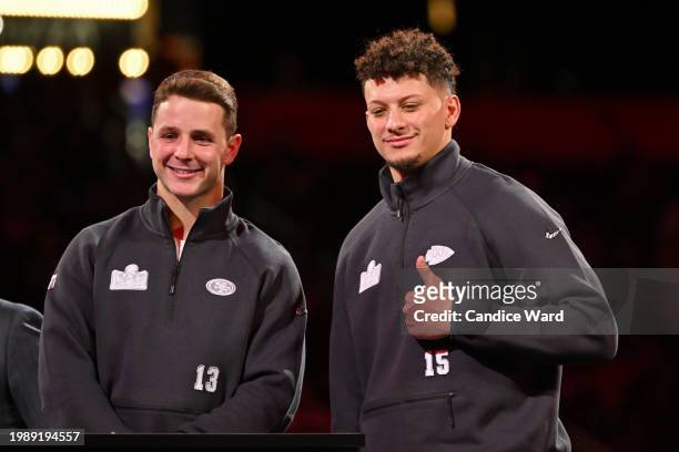 Brock Purdy of the San Francisco 49ers and Patrick Mahomes of the Kansas City Chiefs stand on stage during Super Bowl LVIII Opening Night at...