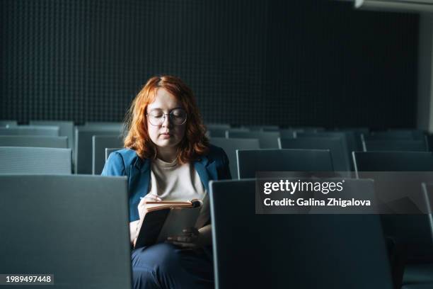 young red haired woman plus size in blue suit working in conference room in the office - sporting training and press conference stock pictures, royalty-free photos & images