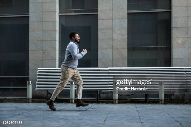 young man rushing to work - one person running stock pictures, royalty-free photos & images
