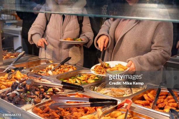 Eat as much as you like hot buffet at a Chinese restaurant in Chinatown on 5th February 2024 in London, United Kingdom. Many people eat bargain food...