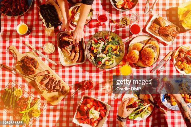 top view of fast food, hands and people at picnic, lunch meal or snack with barbecue, casual cuisine for nutrition and health. diner, cooking and culinary experience with buffet or summer restaurant - restaurant table overhead stock pictures, royalty-free photos & images