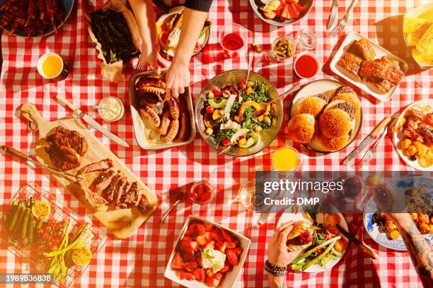 top view of fast food, hands and people at picnic, lunch meal or snack with barbecue, casual cuisine for nutrition and health. diner, cooking and culinary experience with buffet or summer restaurant - sausages stock pictures, royalty-free photos & images