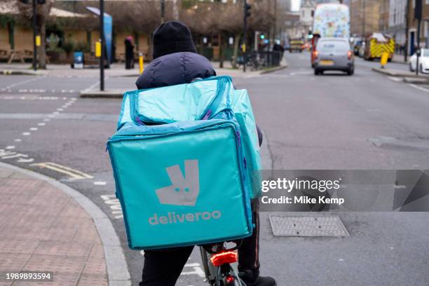 Deliveroo takeaway delivery cycle courier on 7th February 2024 in London, United Kingdom. Deliveroo acts as an intermediary between independent...