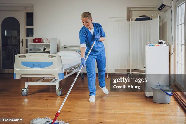 woman mopping floor at the hospital ward - hospital orderly stock pictures, royalty-free photos & images
