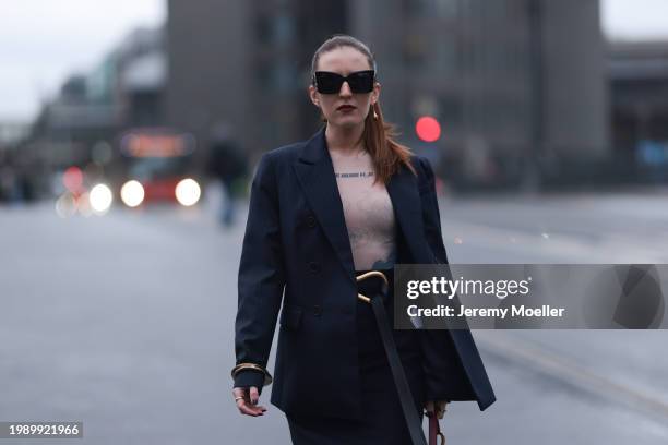 Dariia Prokopovych seen wearing YSL black logo sunglasses, gold earrings, TTSWTRS beige transparent logo / flower print pattern long sleeves body,...