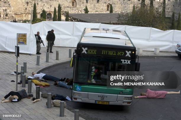 Israeli policemen stand near dolls representing victims during a drill simulating a suicide attack in a bus at the plaza next to the Western Wall in...
