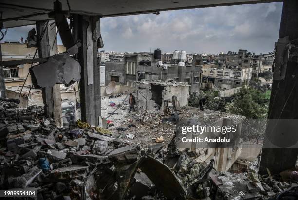 Palestinians search for their belongings at the destroyed building after an Israeli attack that continues in Rafah, Gaza on February 9, 2024.