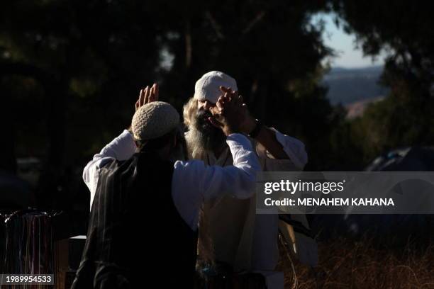 Ultra religious Jewish men greet each other during a music festival named "The end of Days" on a hill next to the Bath Ain settlement in the West...