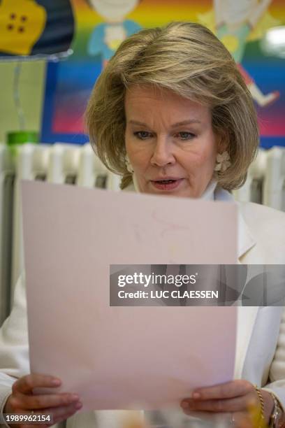 Queen Mathilde of Belgium reads a letters in front of pupils and teachers during a royal visit to Salto primary school for context of the Flemish...