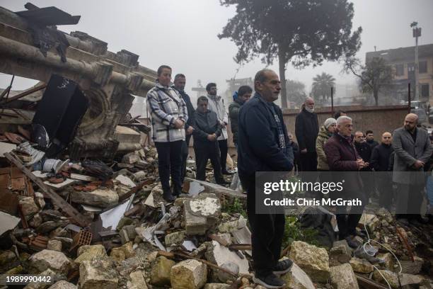 People attend a commemoration mass at the destroyed 18th century St Paul's Church during the first anniversary of last years earthquake on February...