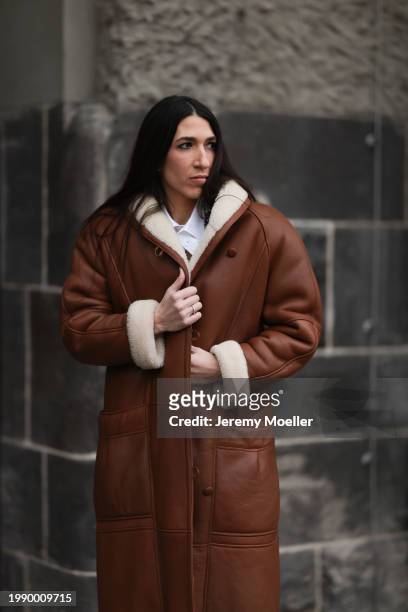 Sara Lazarevic seen wearing white cotton buttoned shirt / blouse, brown leather long coat, on February 05, 2024 in Berlin, Germany.