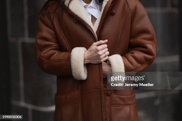 Sara Lazarevic seen wearing white cotton buttoned shirt / blouse, brown leather long coat, on February 05, 2024 in Berlin, Germany.