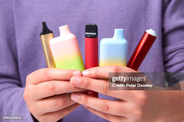 schoolboy holding vapes in school - vaping danger stock pictures, royalty-free photos & images