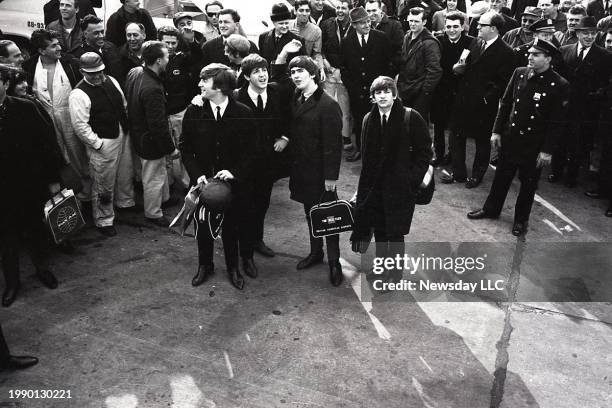 The Beatles pose at Kennedy Airport in Queens, New York after arriving there on February 7, 1964. From left to right, John Lennon, Paul McCartney,...