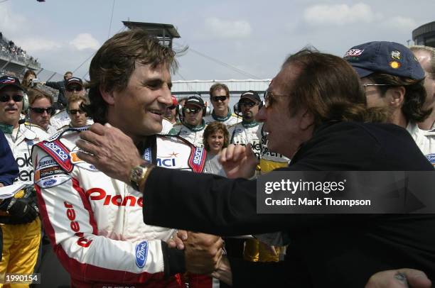 Ex Formula 1 and CART racing driver Alex Zanardi is congrarulated by motor racing legend Emmerson Fittapaldi after driving his specially adapted Cart...