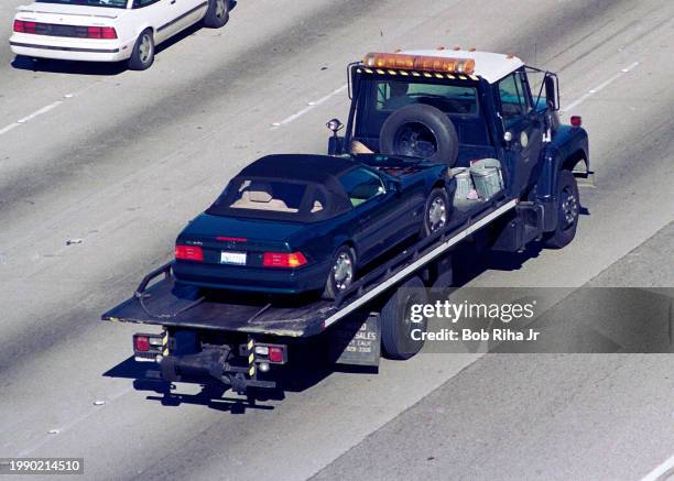 Los Angeles Police Department Tow Truck leaves Crime Scene with vehicle of Ennis Cosby, son of Comedian Bill Cosby, was gunned down and killed while...