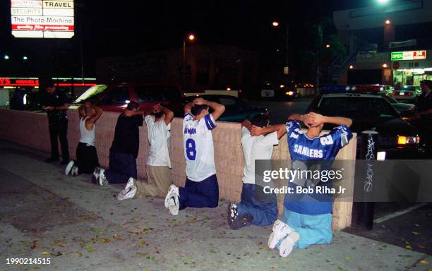 Los Angeles Police Officers questions a group of individuals during a traffic stop along Hollywood Boulevard near Walk of Fame, September 20, 1996 in...