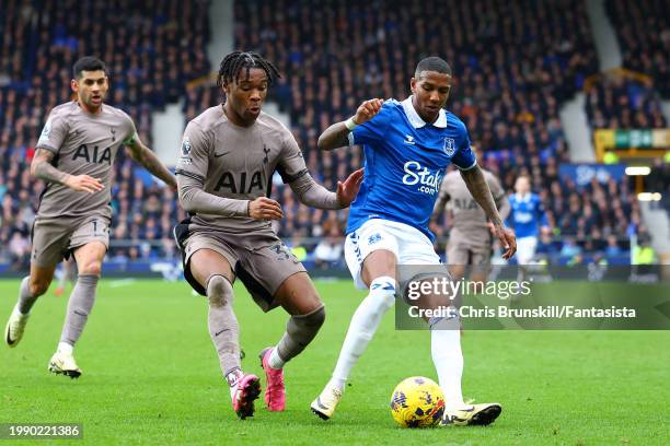 Ashley Young of Everton in action with Desting Udogie of Tottenham Hotspur during the Premier League match between Everton FC and Tottenham Hotspur...