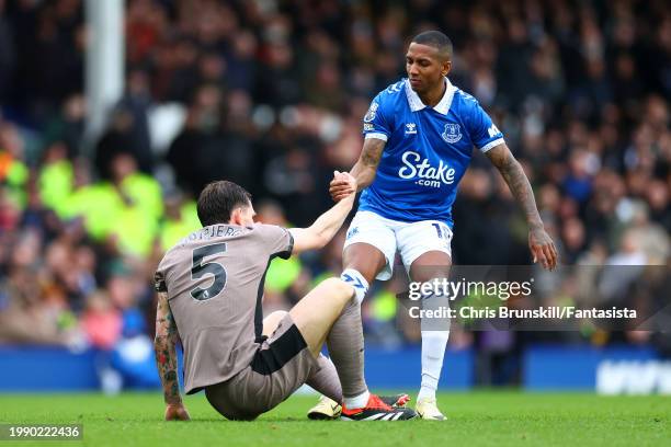 Ashley Young of Everton helps up Pierre-Emile Hojbjerg of Tottenham Hotspur during the Premier League match between Everton FC and Tottenham Hotspur...