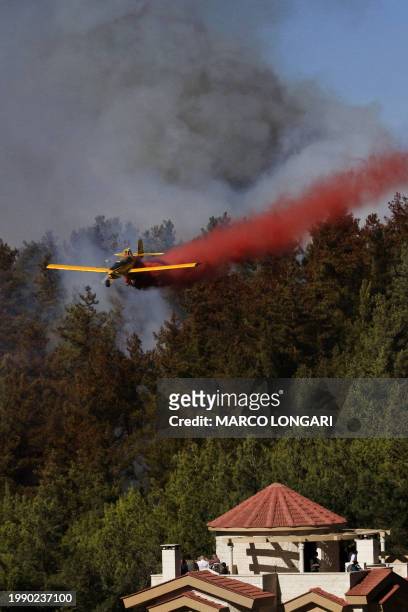 Members of the Israeli Druze community look at the latest front of the raging flames near the village of Ussafiya in Haifa's Carmel forest on...