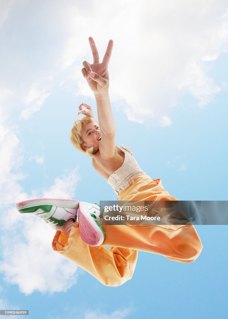 Woman posing making peace sign