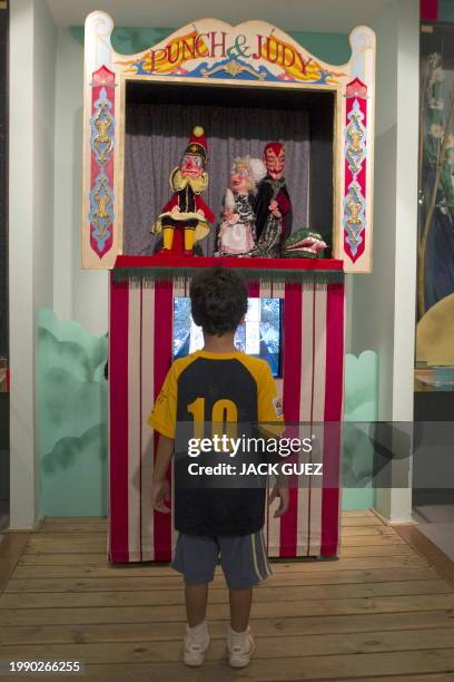 Israeli visitors tour a puppets exhibition at the Puppet Theater Center on July 20, 2010 in Holon, south of the coastal city of Tel Aviv, during the...