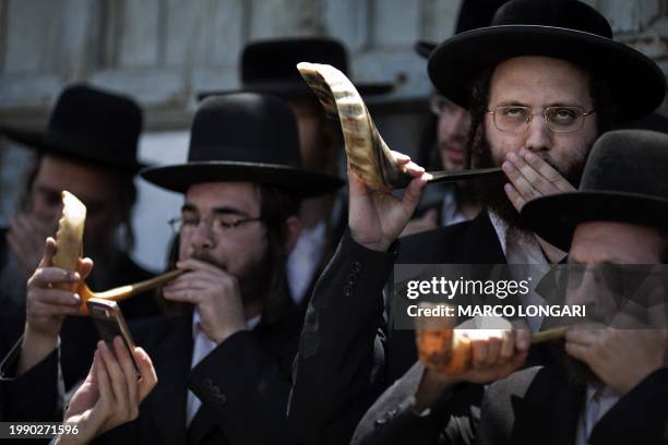 Ultra Orthodox Jews blow the Shofar during a protest against the building company "Electra", which according to protesters plans the removal of...