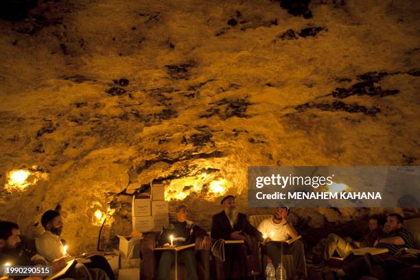 Kabbalist Rabi Uri Revach sits among his students during overnight Kabbalah studies inside a Jerusalem mountain cave near the village of Beit Meir on...