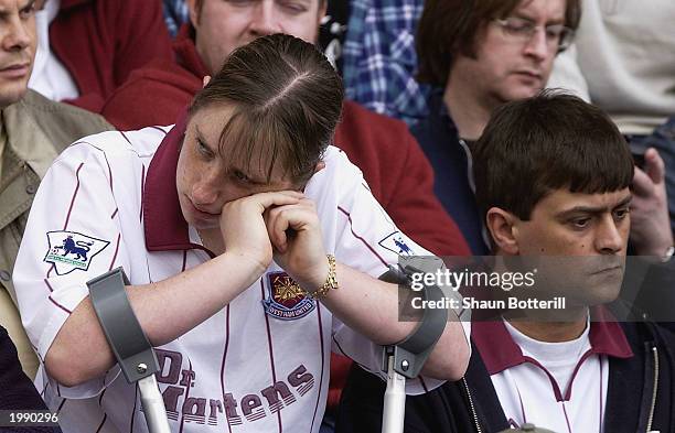 Dejected looking West Ham United fan rests her head on her hands during the FA Barclaycard Premiership match between Birmingham City and West Ham...