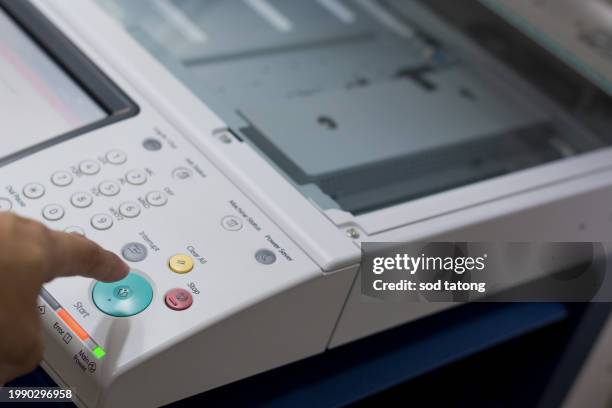 bussiness man hand press button on panel of printer, printer scanner laser in office copy machine supplies start concept - imprimante photos et images de collection