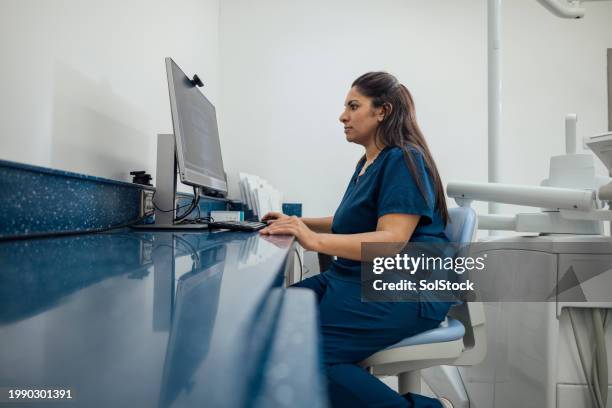 dentist looking at an x-ray image - medical technical equipment stock pictures, royalty-free photos & images