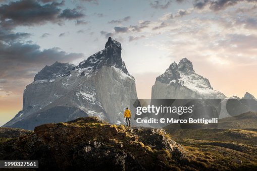Hiker admiring the Cuernos del Paine range, Patagonia Hiker admiring the Cuernos del Paine range, Patagonia
