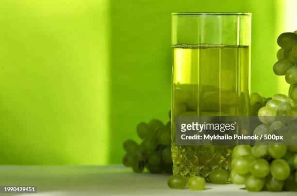 close-up of grapes in glass bottle on table - lawn aeration stock pictures, royalty-free photos & images