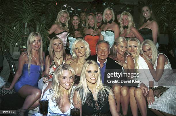 Playboy founder Hugh Hefner and playmates pose in front of the touring Playmates and the Dewar's Highlander on May 8, 2003 in Bel Air, California....