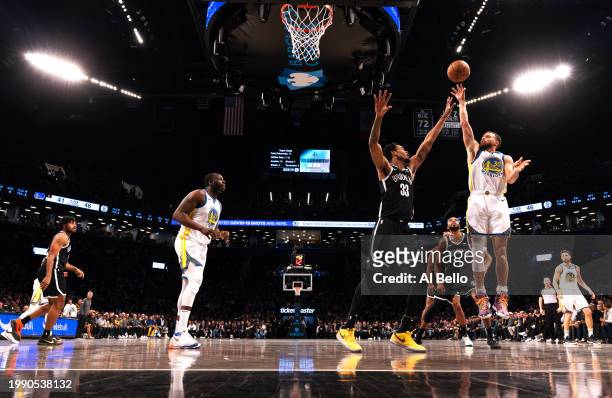 Stephen Curry of the Golden State Warriors shoots against Nic Claxton of the Brooklyn Nets during their game at Barclays Center on February 05, 2024...