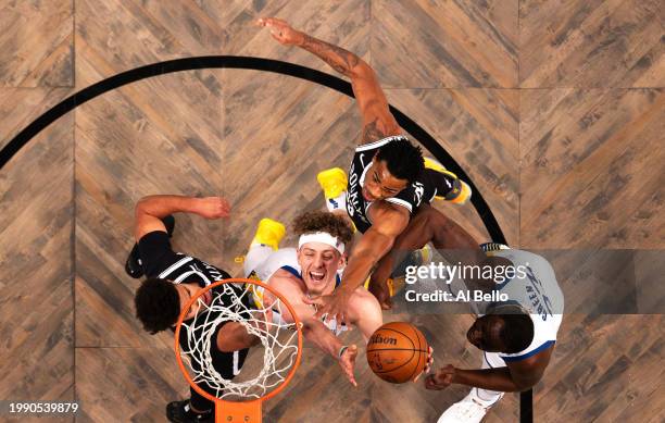 Brandin Podziemski , and Draymond Green of the Golden State Warriors battle Nic Claxton and Cameron Johnson of the Brooklyn Nets for the ball during...