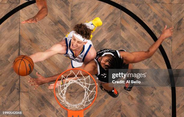 Brandin Podziemski of the Golden State Warriors shoots against Cam Thomas of the Brooklyn Nets during their game at Barclays Center on February 05,...