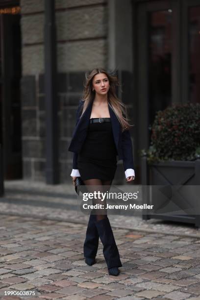 Joelle Marie Jaracz seen wearing navy blue short blazer jacket, black belted bandeau sleeveless short dress, black tights, black leather bag, gold...