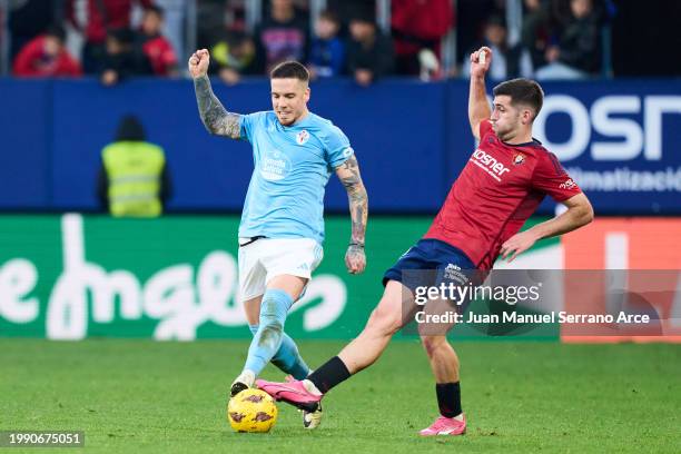 Mihailo Ristic of RC Celta Vigo duels for the ball with Jesus Areso Blanco of CA Osasuna during the LaLiga EA Sports match between CA Osasuna and...