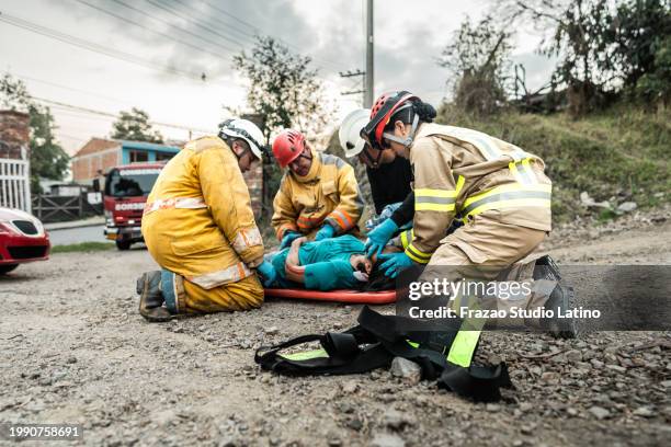 firefighters helping a car accident victim - 911 images stock pictures, royalty-free photos & images