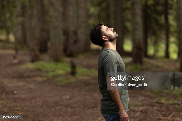 young man relaxing in forest - man breathing stock pictures, royalty-free photos & images