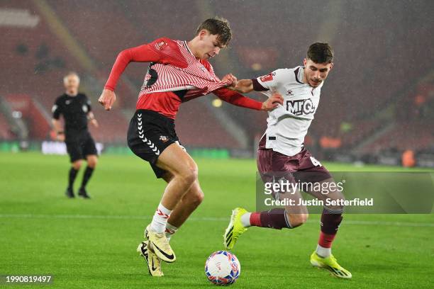 Tyler Dibling of Southampton is challenged by under pressure from James Morris of Watford during the Emirates FA Cup Fourth Round Replay match...