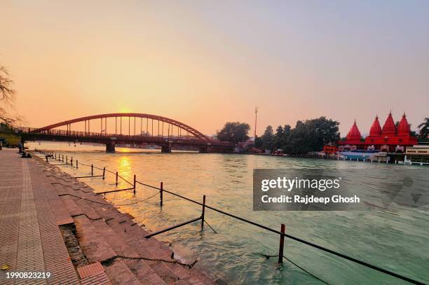 sunset over bridge on the ganges river in haridwar india - chain bridge suspension bridge stock pictures, royalty-free photos & images