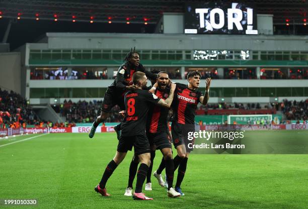 Jonathan Tah of Bayer Leverkusen celebrates scoring his team's third goal with teammates during the DFB cup quarterfinal match between Bayer 04...