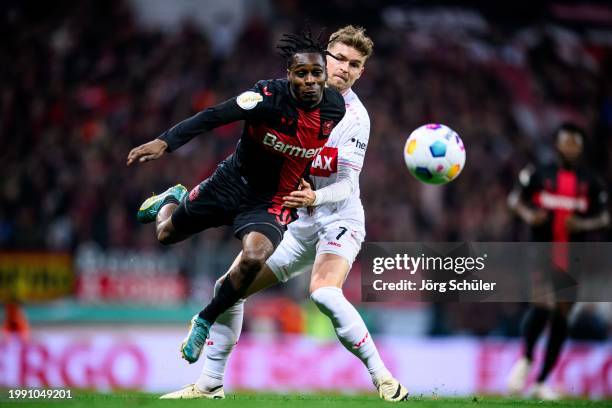 Jeremie Frimpong of Leverkusen is challenged by Maximilian Mittelstaedt of Stuttgart during the DFB cup quarterfinal match between Bayer 04...