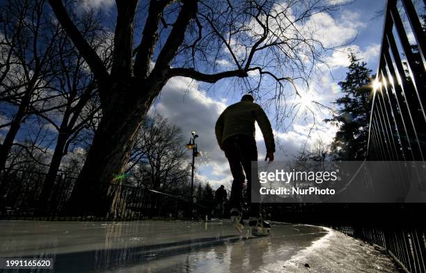 Skater is enjoying the sunny skies and unseasonably warm weather while skating at Gage Park in downtown Brampton, Ontario, Canada, on February 9,...