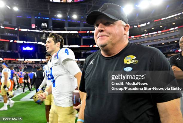 Pasadena, CA Head coach Chip Kelly of the UCLA Bruins walks off the field with quarterback Ethan Garbers of the UCLA Bruins after defeating the Boise...