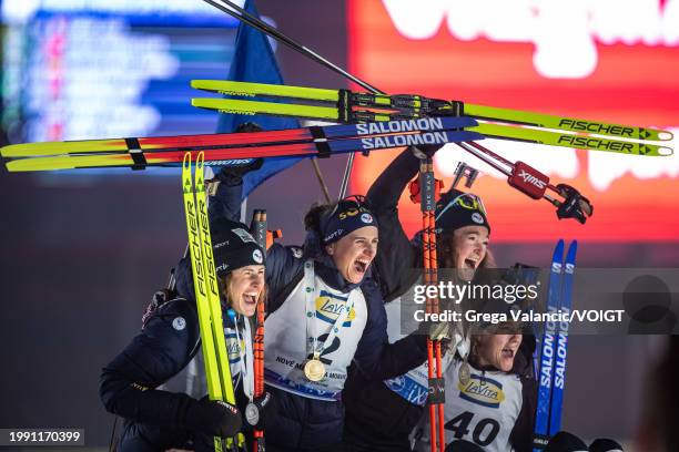 Julia Simon of France, Justine Braisaz-Bouchet of France, Lou Jeanmonnot of France and Sophie Chauveau of France celebrate after the medal ceremony...
